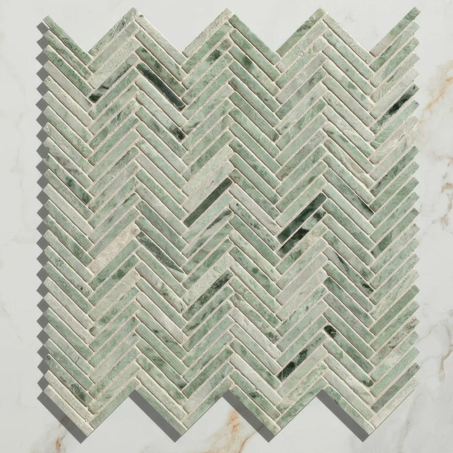 Athens mint marble mosaic green and white veined marble tiles arranged in a herringbone pattern for flooring or walls