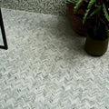 Herringbone-patterned athens mint marble mosaic tile floor in white and gray tones for elegant interiors