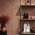 Athens Rosso Travertine Mosaic reddish-brown travertine herringbone mosaic styled with an earthenware pitcher