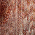 Athens Rosso travertine mosaic with reddish-brown bricks laid in a herringbone pattern with white mortar
