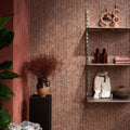 Athens Rosso Travertine Mosaic reddish-brown travertine herringbone mosaic styled with a speckled earthenware vase