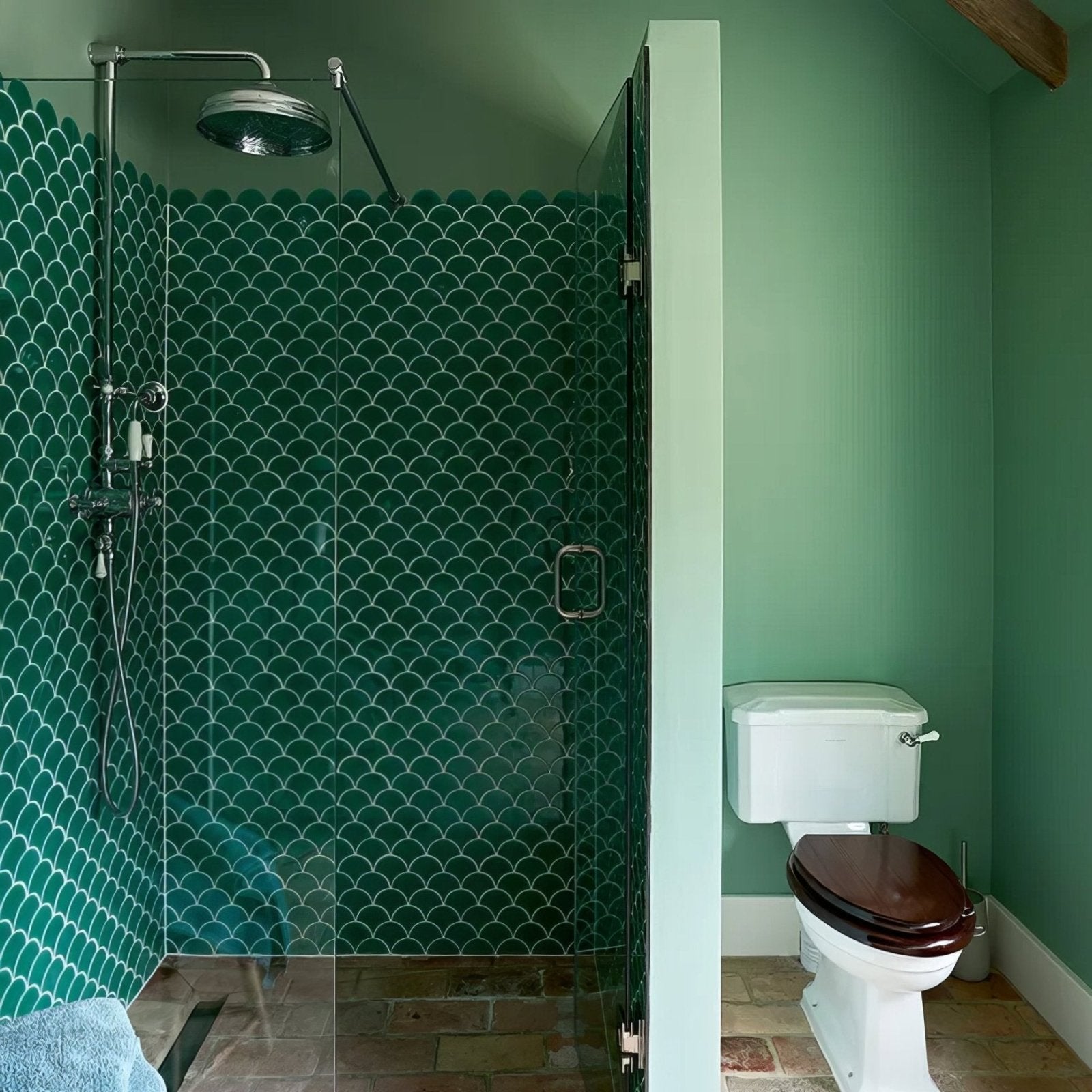 Emerald green scalloped porcelain mosaic tile wall with chrome fixtures in a shower using atlantis porcelain mosaic emerald