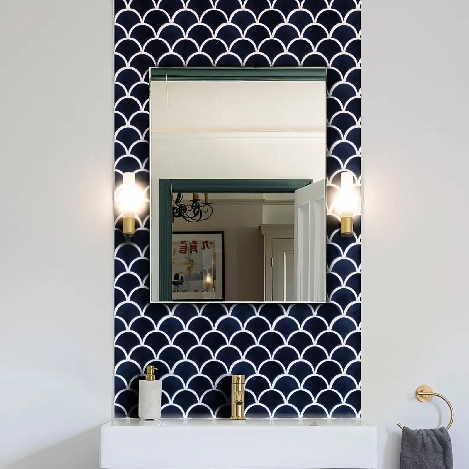 Rectangular mirror with a sleek minimalist frame against navy blue and white scalloped Atlantis porcelain mosaic tiles