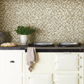 Aura Mosaic beige and olive green mosaic backsplash behind a cream enamel cookstove