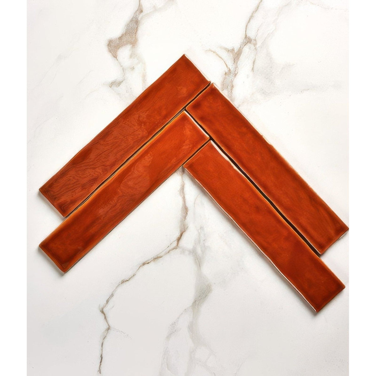 Avebury ceramic burnt caramel ceramic tiles with warm terracotta hue and subtle glossy finish in herringbone pattern