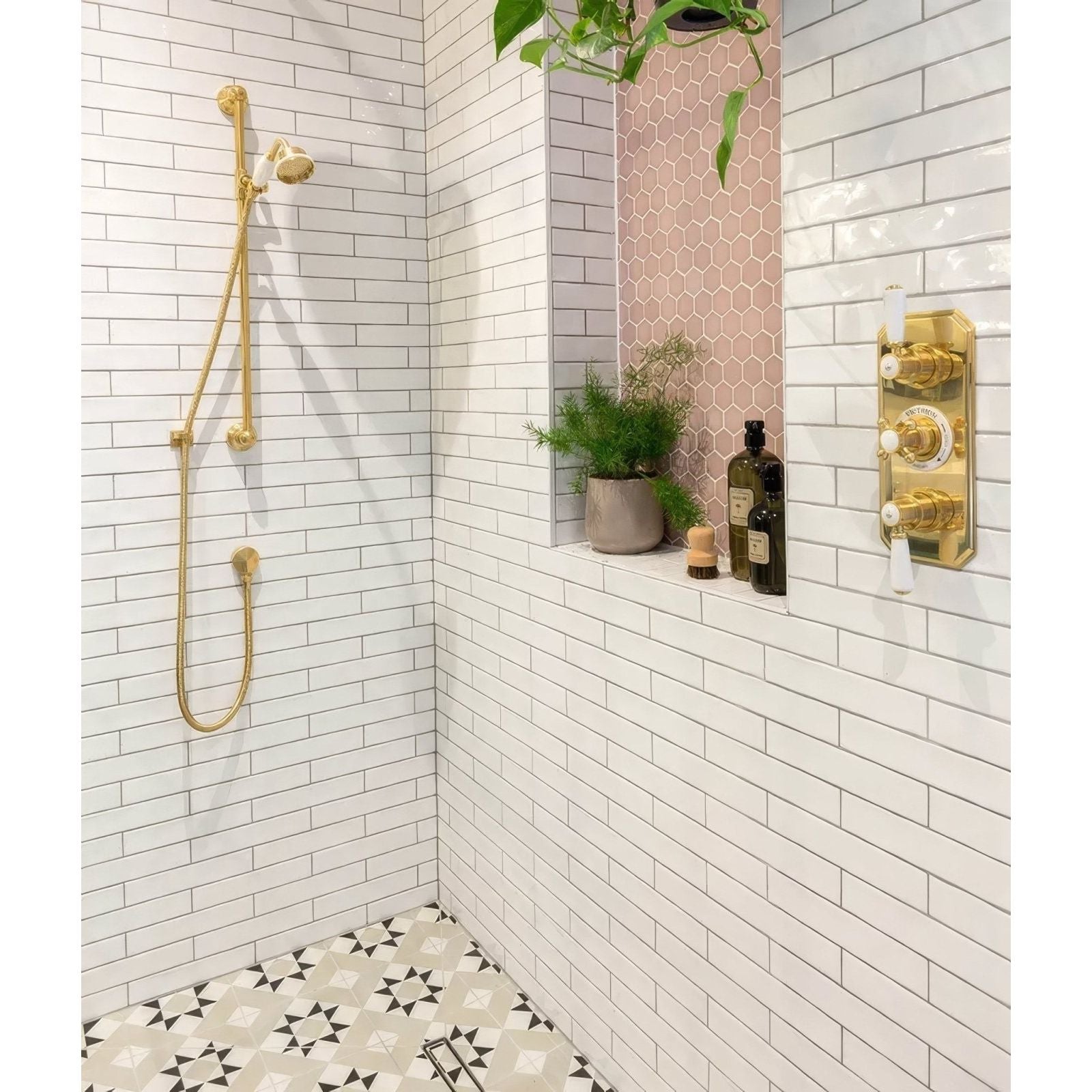 Gold-toned shower fixture with sleek modern design and polished brass finish in avebury ceramic milk white