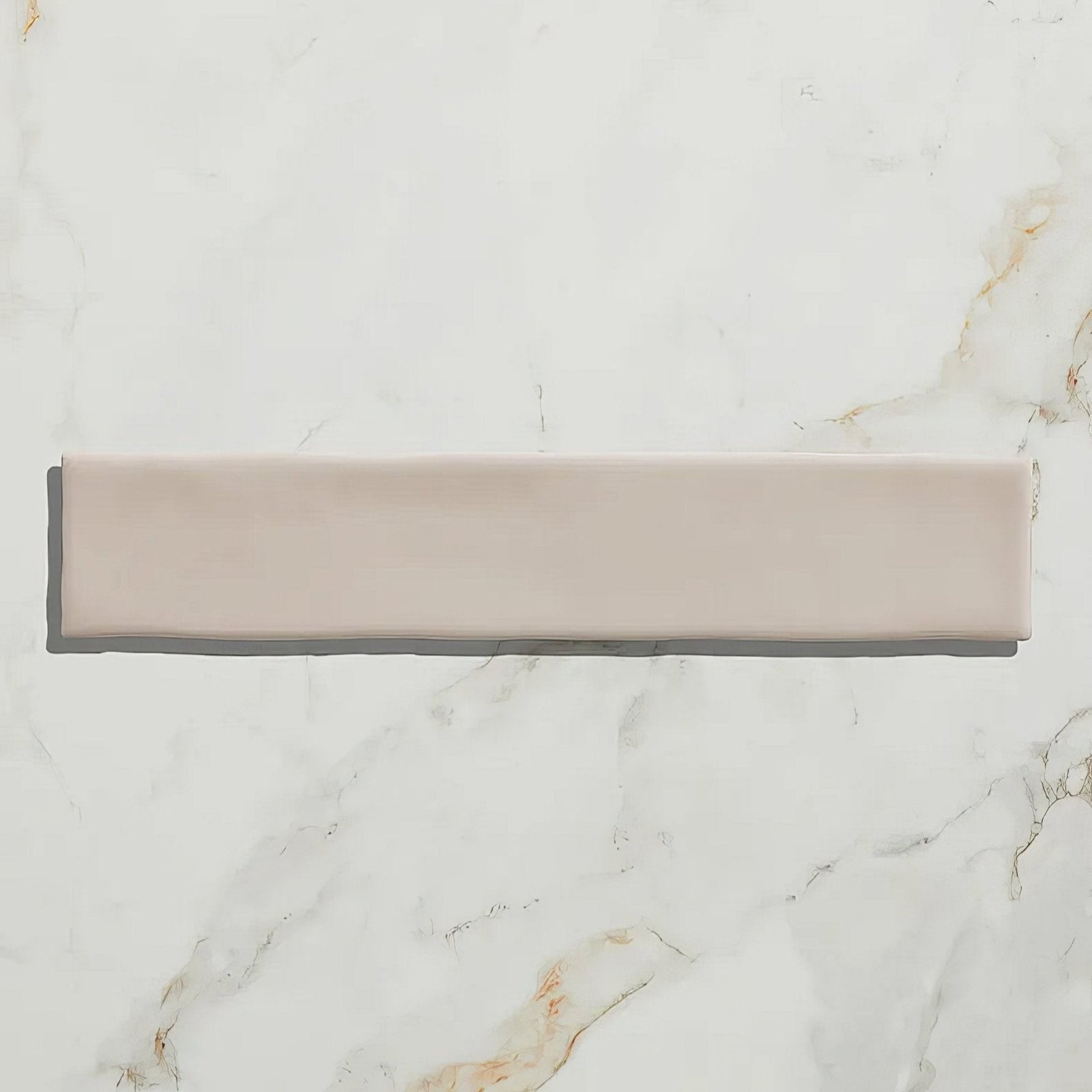 Avebury ceramic plaster sleek matte blush pink rectangular tile with subtle edges on white marble surface