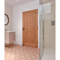Avebury ceramic plaster featuring a light oak wooden door with vertical paneling and a black handle