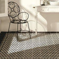 Avignon Black on Dover White black and white geometric pattern tiles with a black wrought iron chair