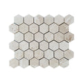 Mesh-backed sheet of Shellstone brushed limestone hexagon mosaic in warm beige tones