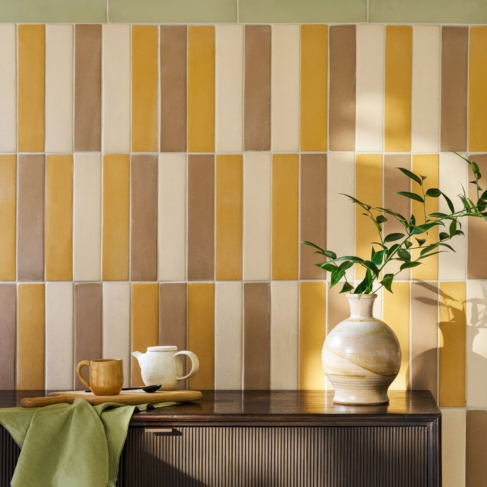 Cream-colored ceramic vase with subtle marbled texture and rounded body featured in balance olive tile collection