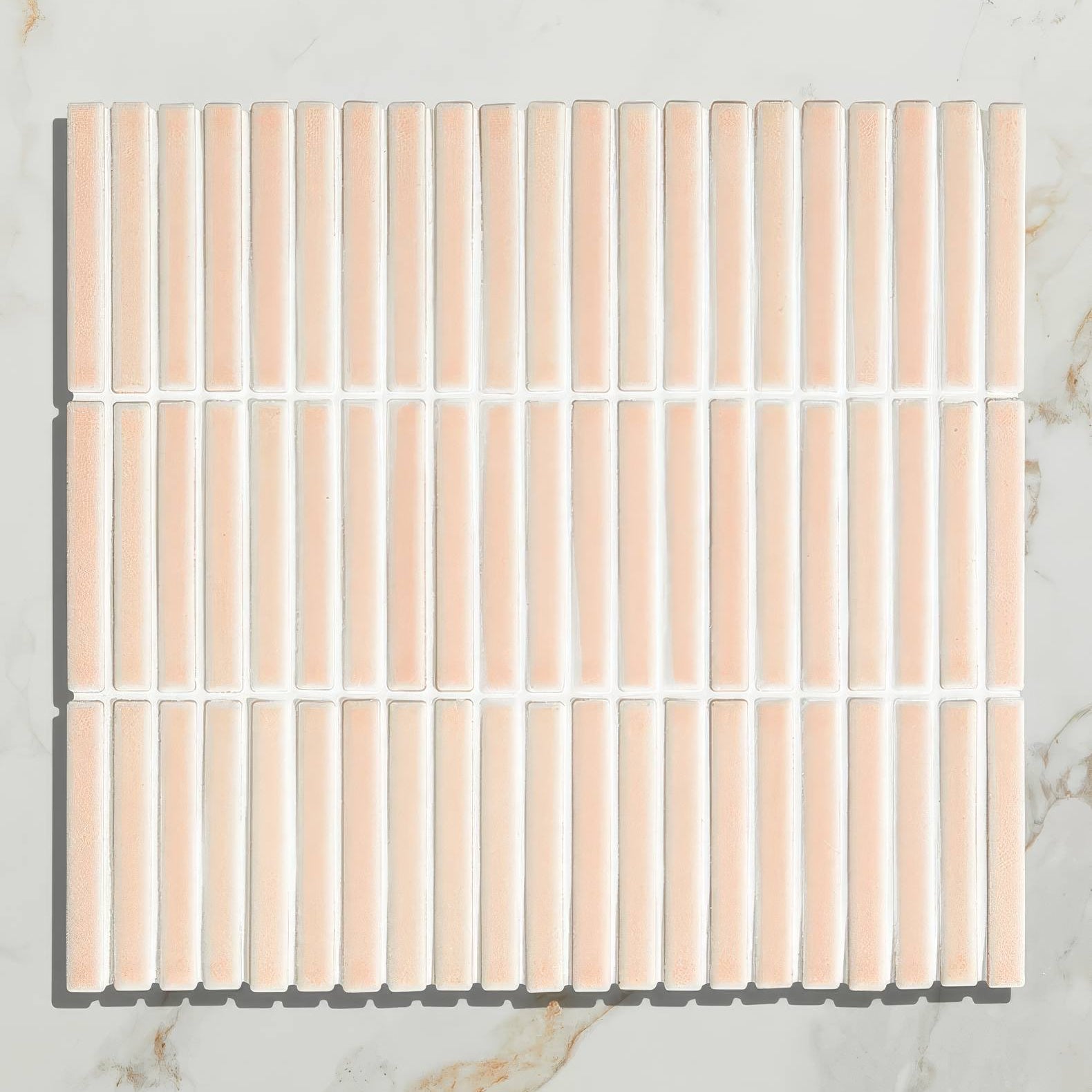 A square bamboo porcelain mosaic blush tile with vertical peach ceramic strips and white grout lines