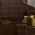 A sleek dark brown bamboo porcelain mosaic tile wall with vertical ridges in caramel tone