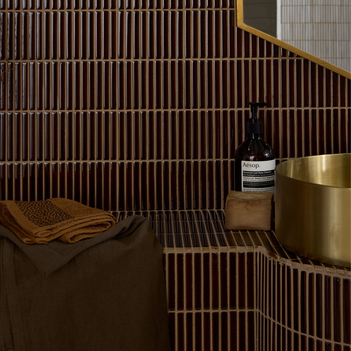 A sleek dark brown bamboo porcelain mosaic tile wall with vertical ridges in caramel tone