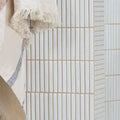 Beige ceramic subway tiles with subtle speckles and vertical ridges in bamboo porcelain mosaic vintage white design