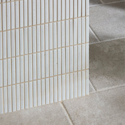 White rectangular ceramic mosaic tiles with subtle speckles arranged in vertical grid pattern bamboo porcelain mosaic vintage white
