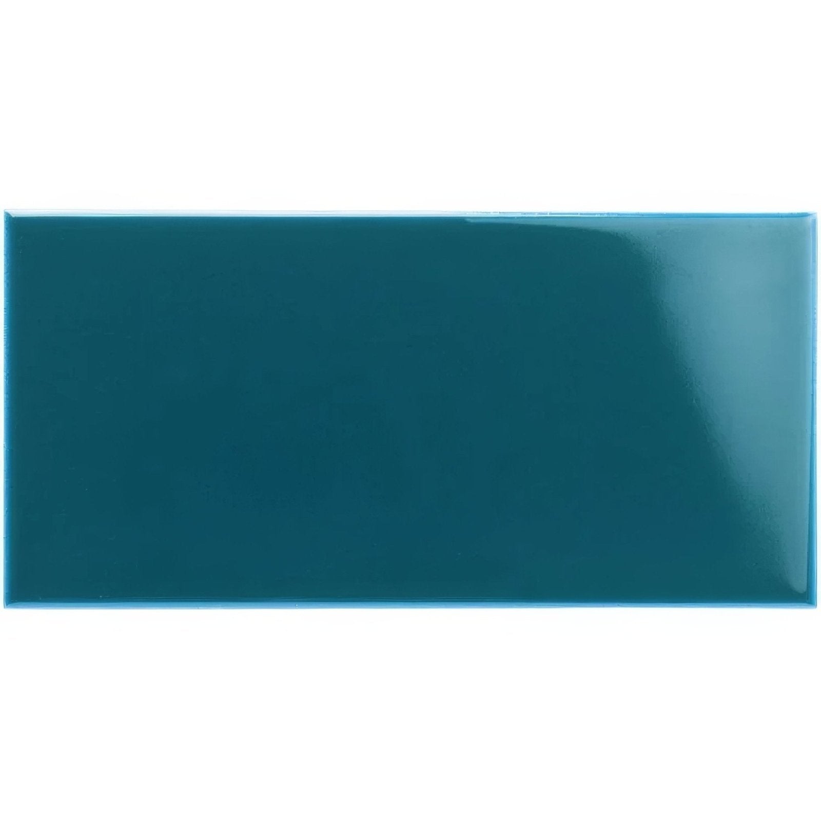A glossy teal rectangular ceramic baroque blue half tile with a smooth reflective surface