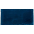 A rectangular deep navy blue ceramic bastille half tile wall tile with a smooth glossy finish