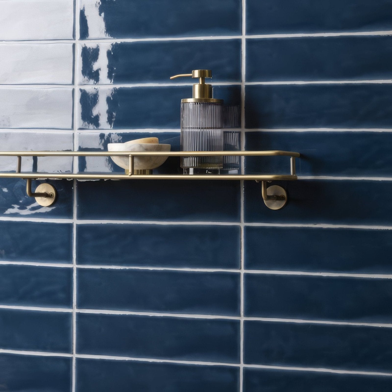 Brass bathroom shelf with sleek minimalist design holding soap dispenser and bowl on bastille large brick tile wall
