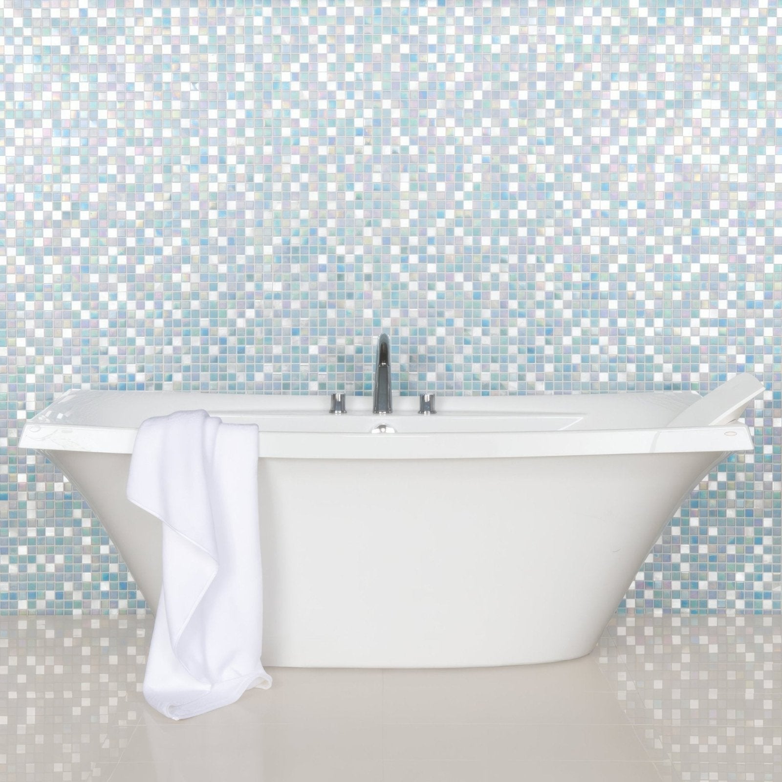 Batu Glass and Metal blue, green and white iridescent glass mosaic behind a freestanding bathtub with a chrome tap