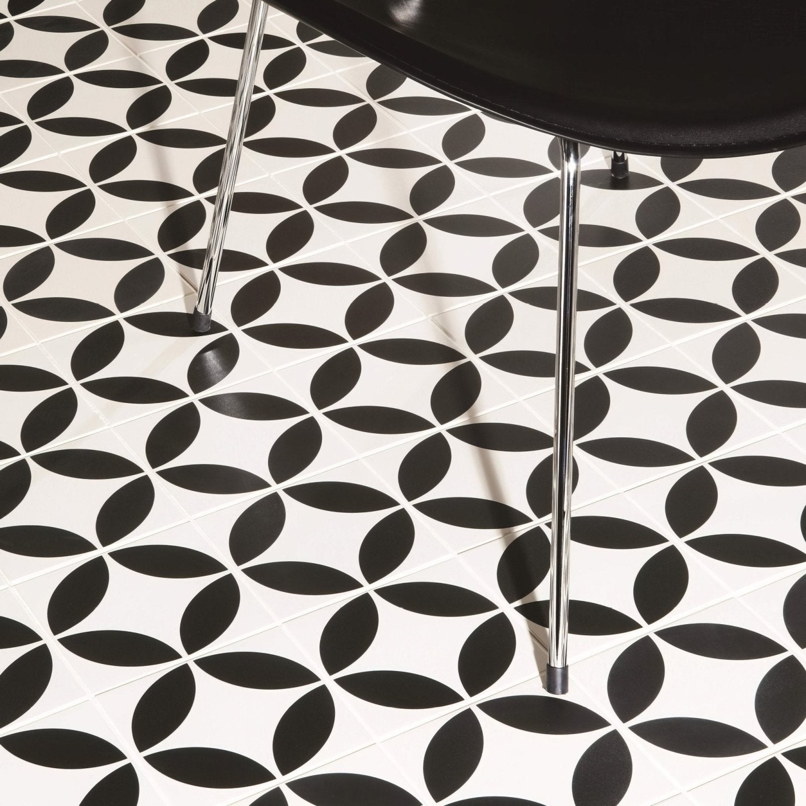 Black and white geometric patterned floor tiles featuring overlapping oval shapes in bavaria black on dover white