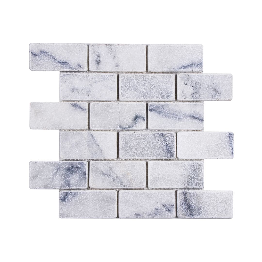 Carrara white tumbled marble brick mosaic sheet laid in a staggered running bond