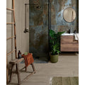 Rustic wooden stool with weathered finish and orange towel draped over it from beach hut porcelain caramel collection