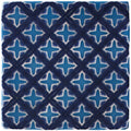 Behen on truffle blue ceramic tile with white quatrefoil pattern set within intersecting diagonal lines