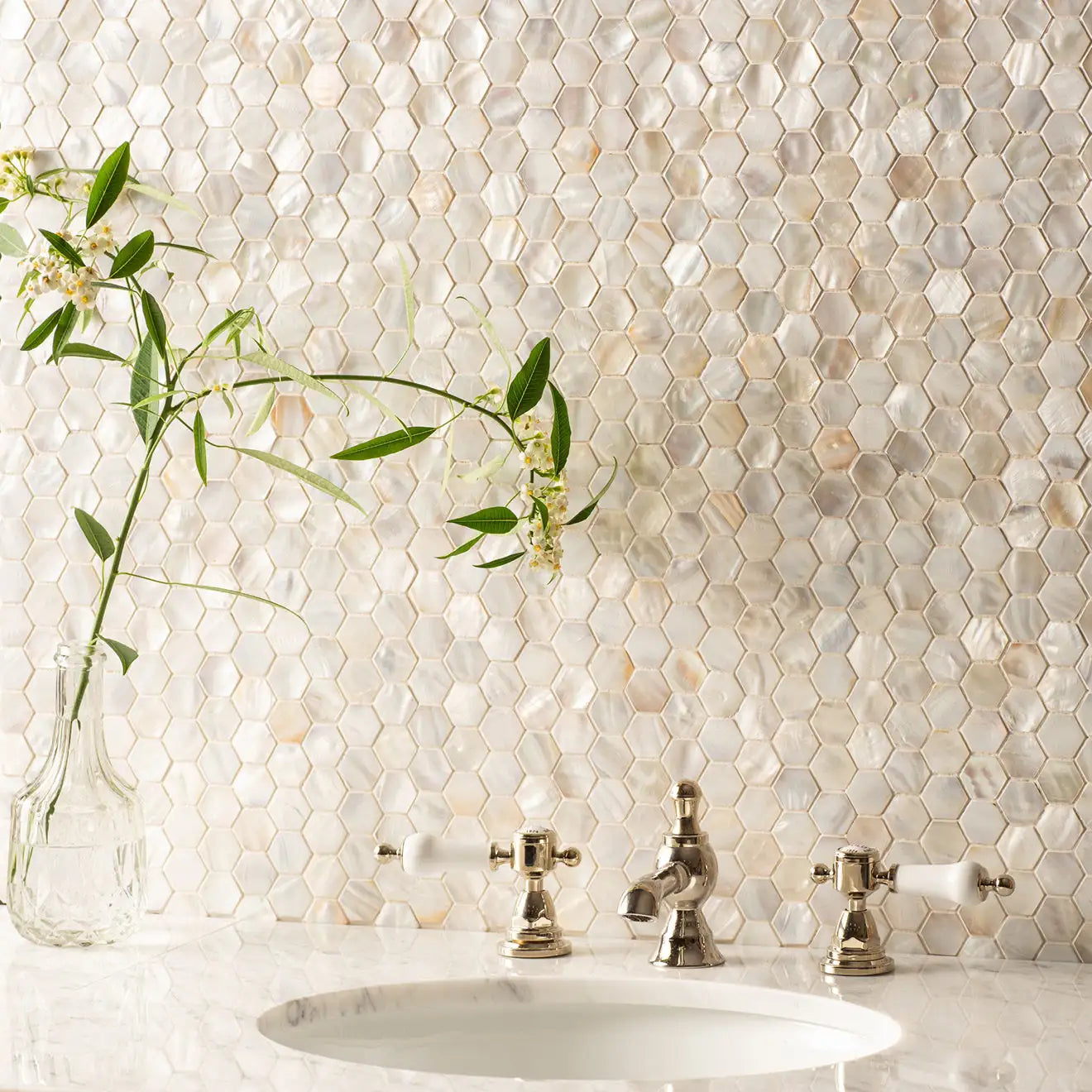 Beige hexagonal mother-of-pearl mosaic tile backsplash.