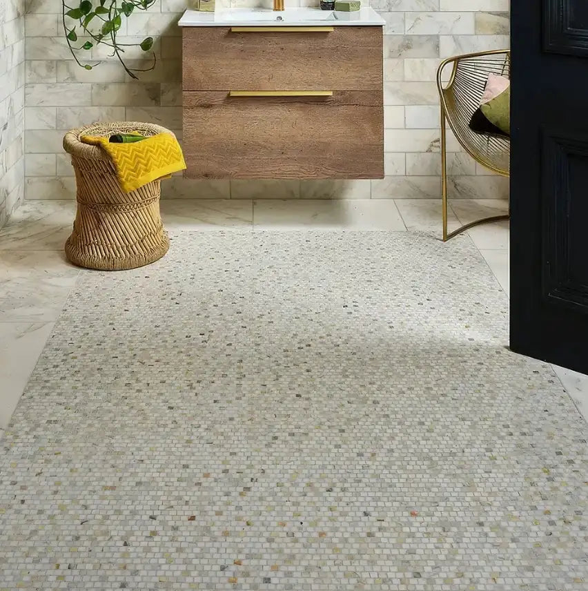 Beige mosaic tile floor with a speckled pattern of subtle earthy tones.