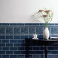 Deep blue ceramic tiles with intricate embossed floral patterns and white grout used as decorative wall accent berkeley on ascot blue