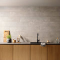 Gray textured concrete wall tiles arranged horizontally from the Berliner Zement Flames collection