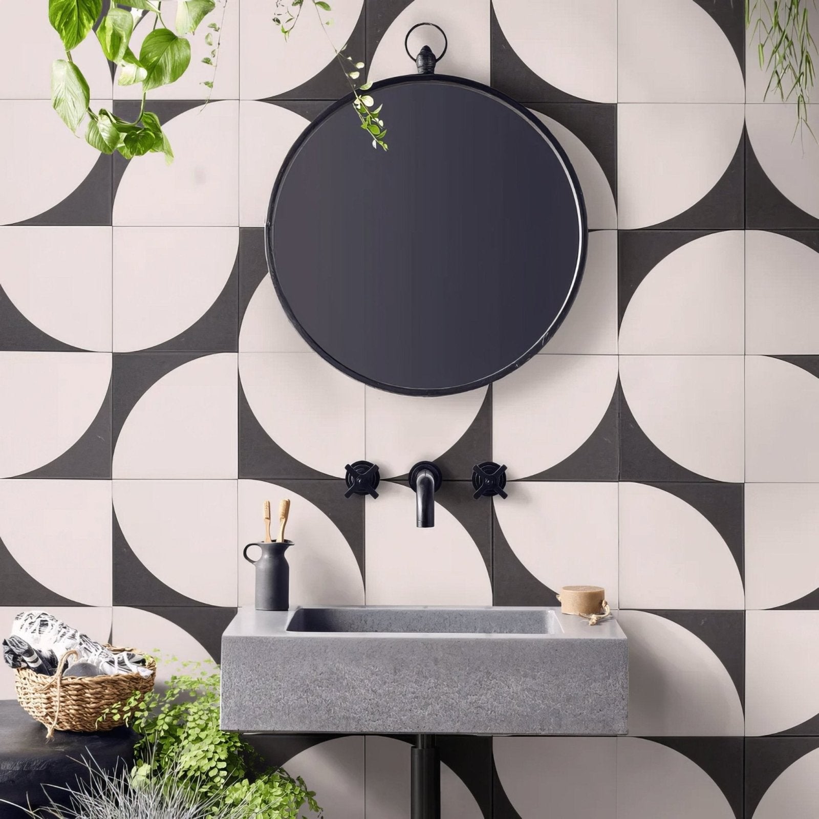 Black round bert & may arco old iron porcelain mirror with sleek metal frame above gray concrete sink
