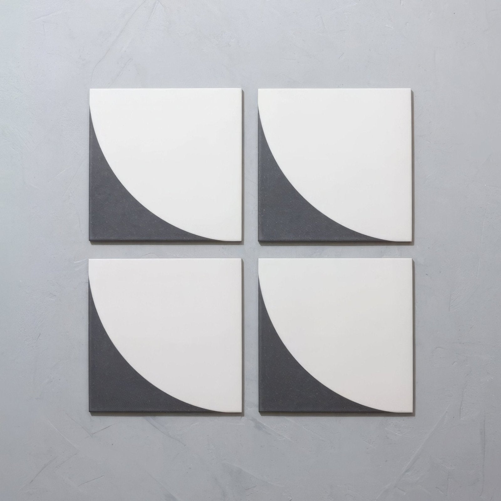 Set of four Bert & May Arco Old Iron porcelain tiles with bold white and dark gray curved geometric design