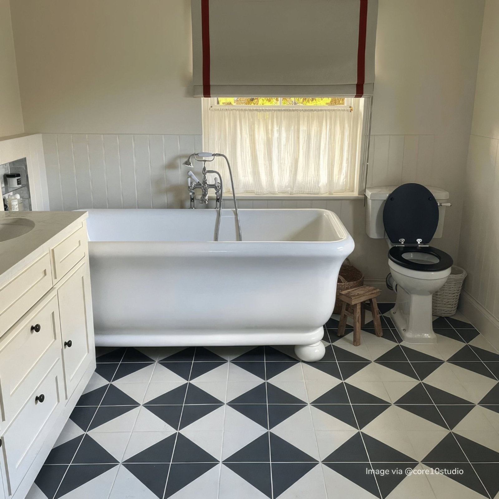 White clawfoot bathtub with chrome fixtures from bert and may black alalpardo porcelain collection