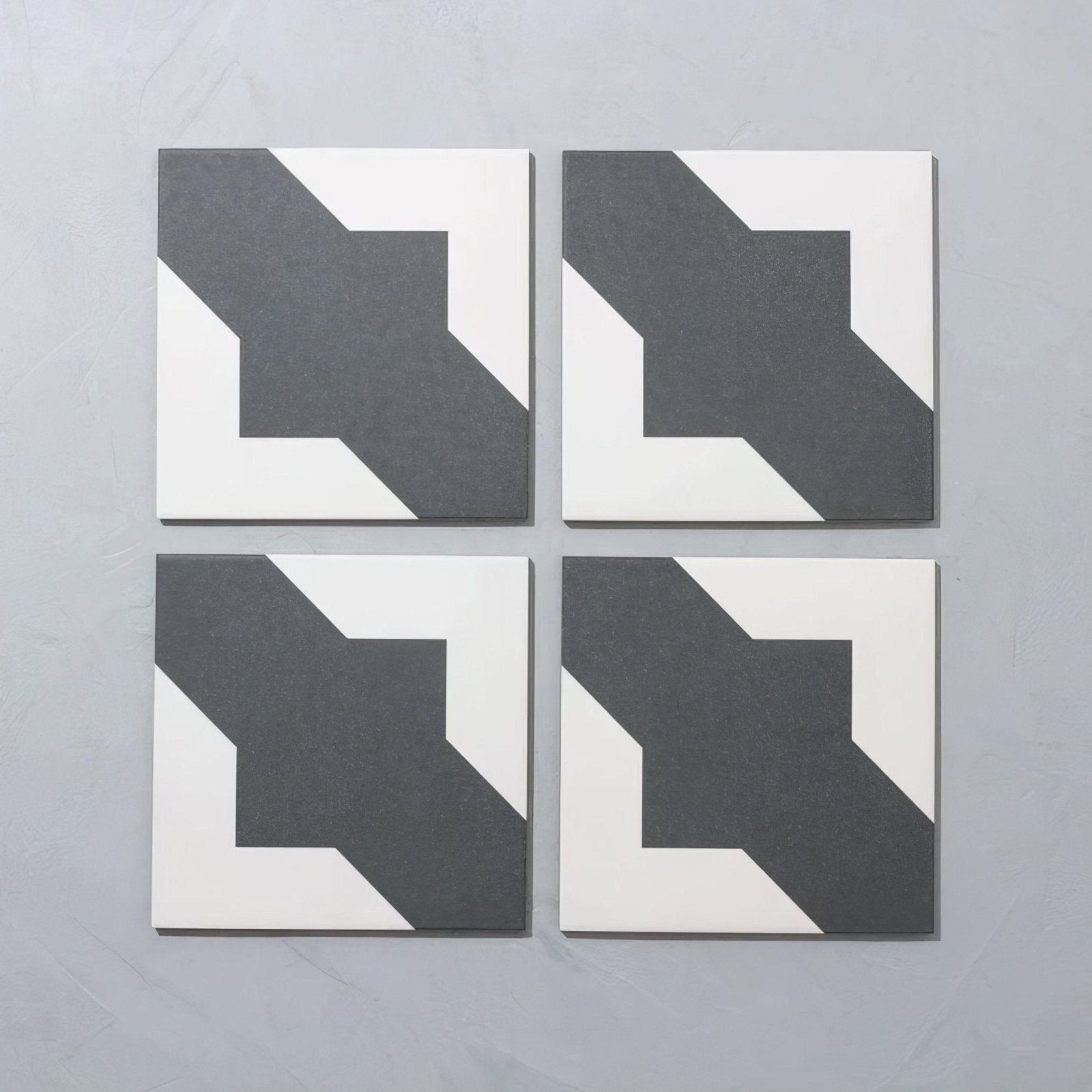 Set of four bert & may black crosses porcelain tiles featuring bold black and white geometric patterns