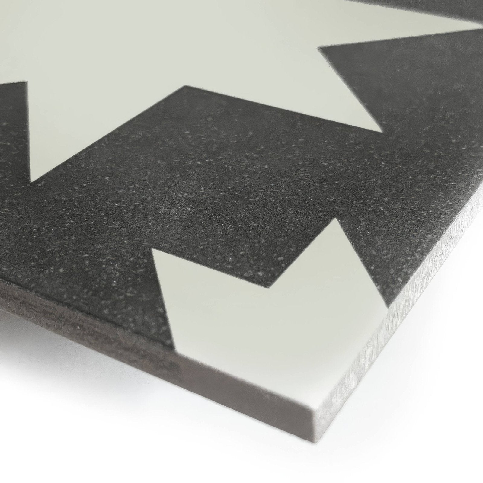 Black and white geometric mosaic tile with speckled texture made of porcelain from bert and may pradena collection