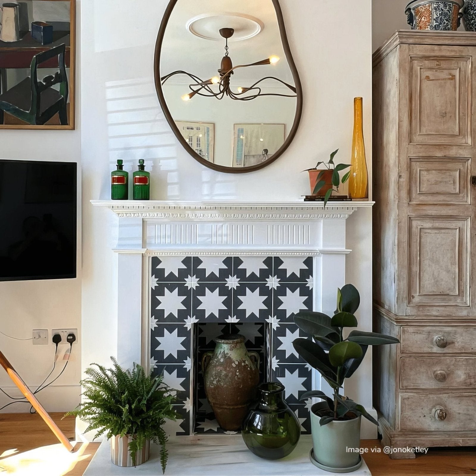 White fireplace featuring black and white star patterned bert and may black pradena porcelain tiles