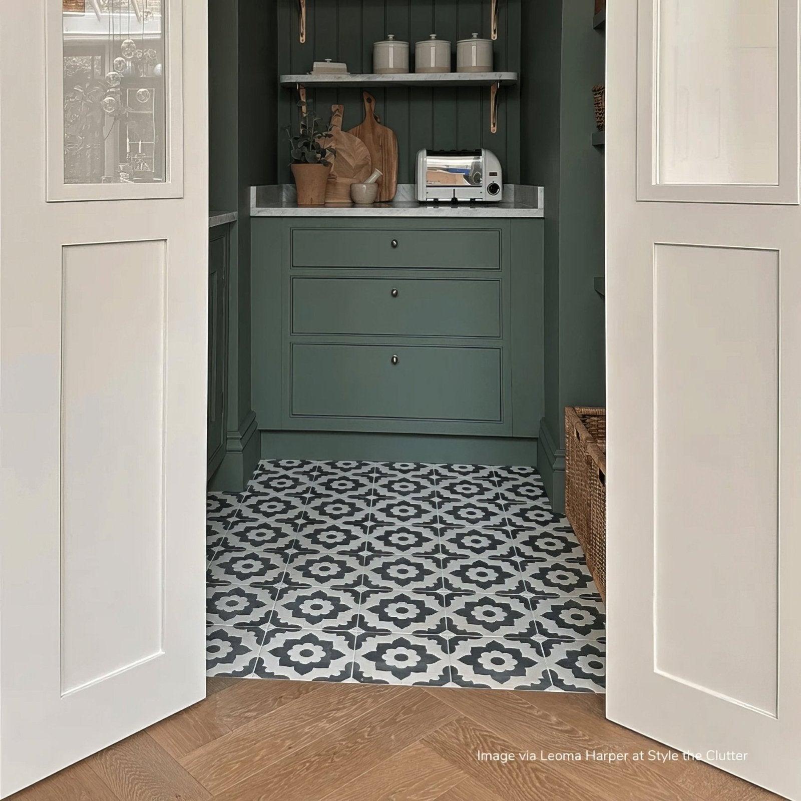 Dark green bert and may black santona porcelain kitchen cabinets with silver knobs and white countertop