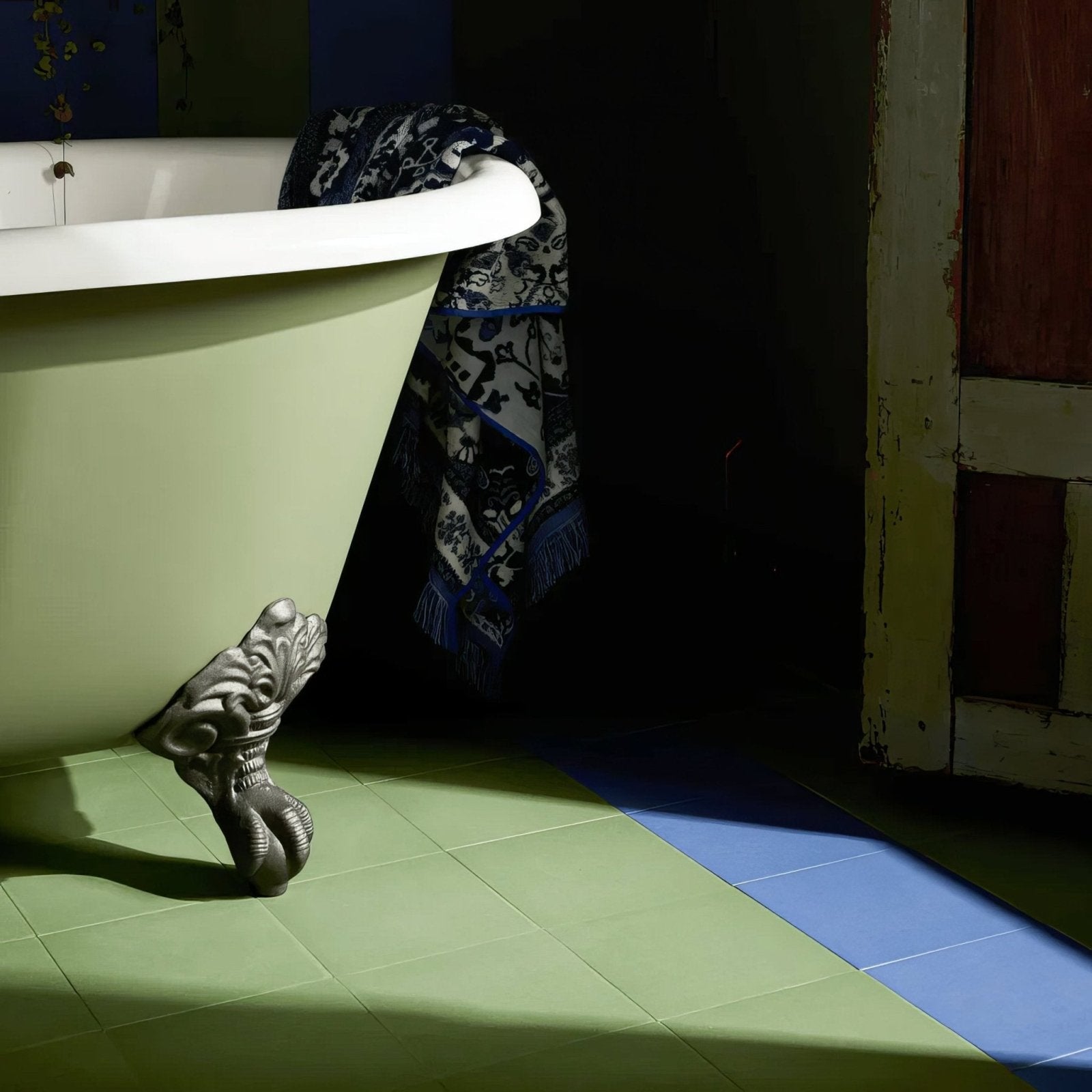 A vintage-style clawfoot bathtub with pale green enamel finish and ornate silver-toned metal feet in bert & may forest porcelain plain tile setting