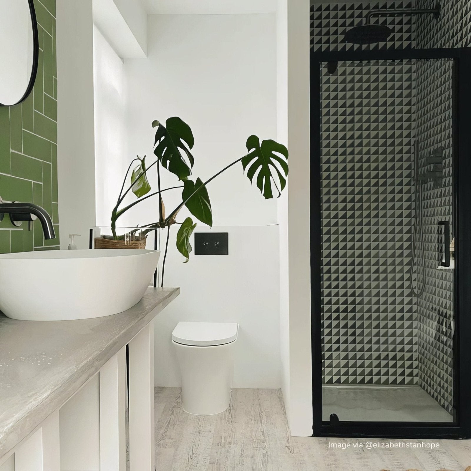 White ceramic bert and may green majadas porcelain vessel sink with matte black faucet on light gray stone countertop