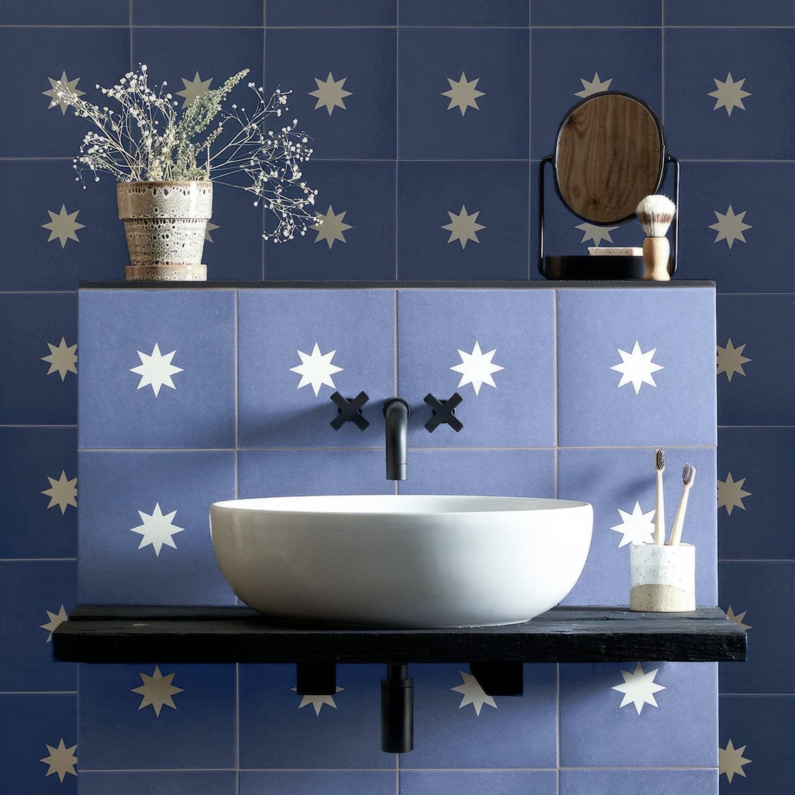 White ceramic vessel sink bert & may navy luna porcelain with sleek black faucet and cross-shaped handles