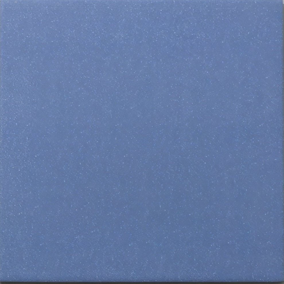 A solid matte-finish blue navy porcelain plain tile with subtle speckled texture by Bert & May