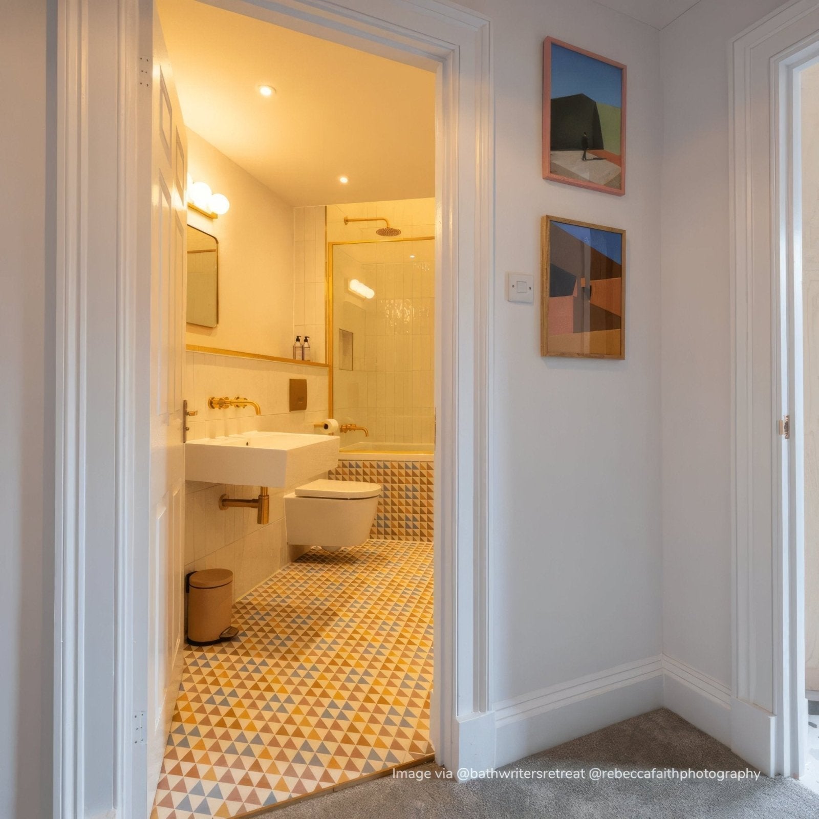 The bert and may soho majadas porcelain tile bathroom features white ceramic fixtures with gold accents on yellow walls
