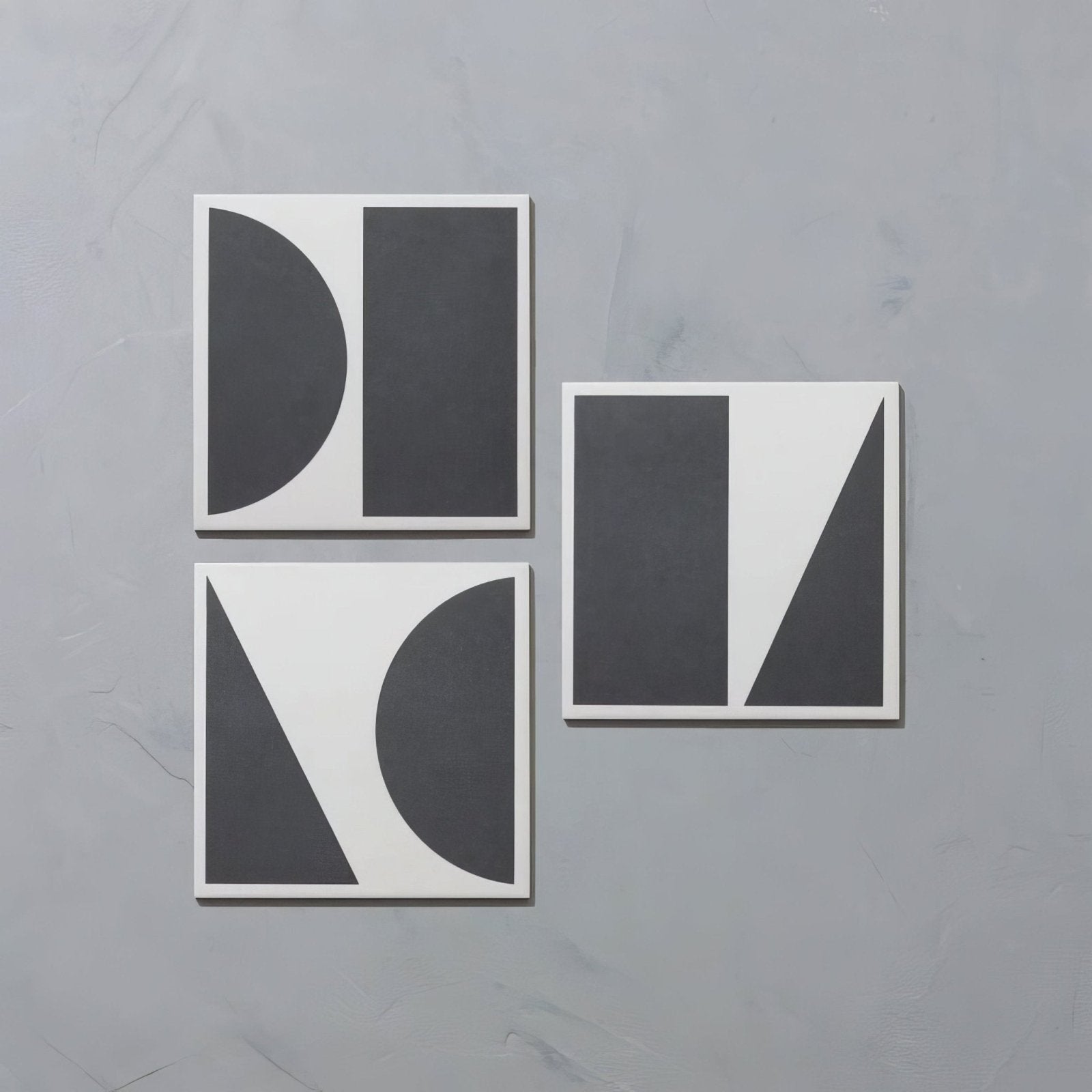 Set of four bert & may split shift old iron porcelain coasters in matte black and white with bold geometric shapes