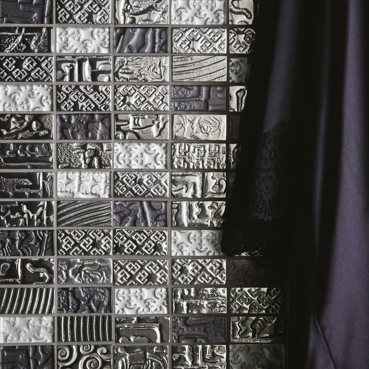 Black and white textured mosaic tile wall with intricate embossed patterns from the bihar mixed mosaic collection