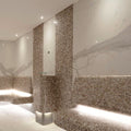 Luxurious beige and brown mosaic tiled sauna with biscotti 25mm square built-in benches and columns