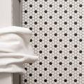 Black and White Honeycomb Floor Mosaic black and white hexagonal mosaic flooring with a white towel draped over it