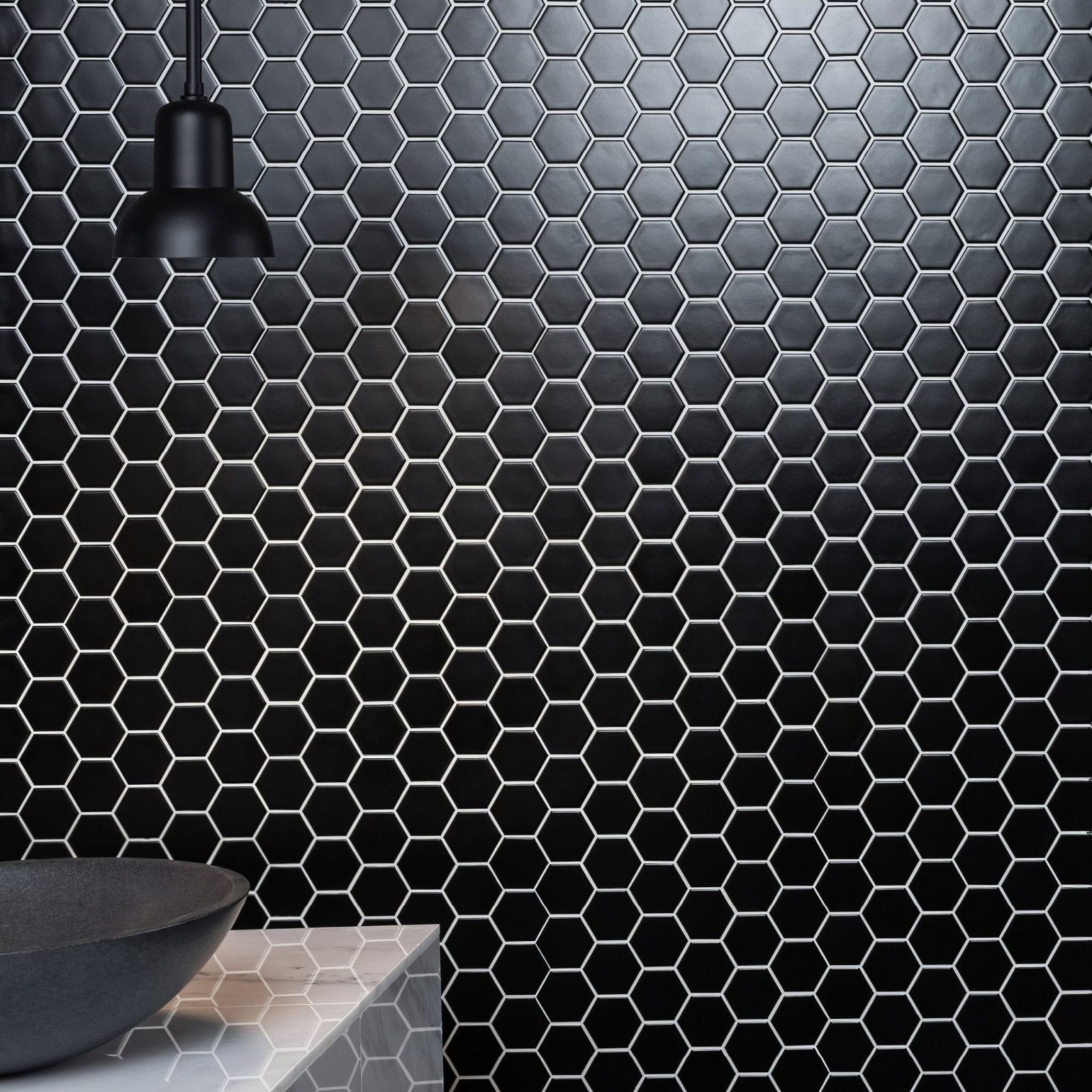 Black large honeycomb floor mosaic with black hexagonal tiles and white grout lines on wall surface