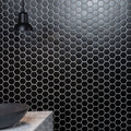 Black large honeycomb floor mosaic with black hexagonal tiles and white grout lines on wall surface